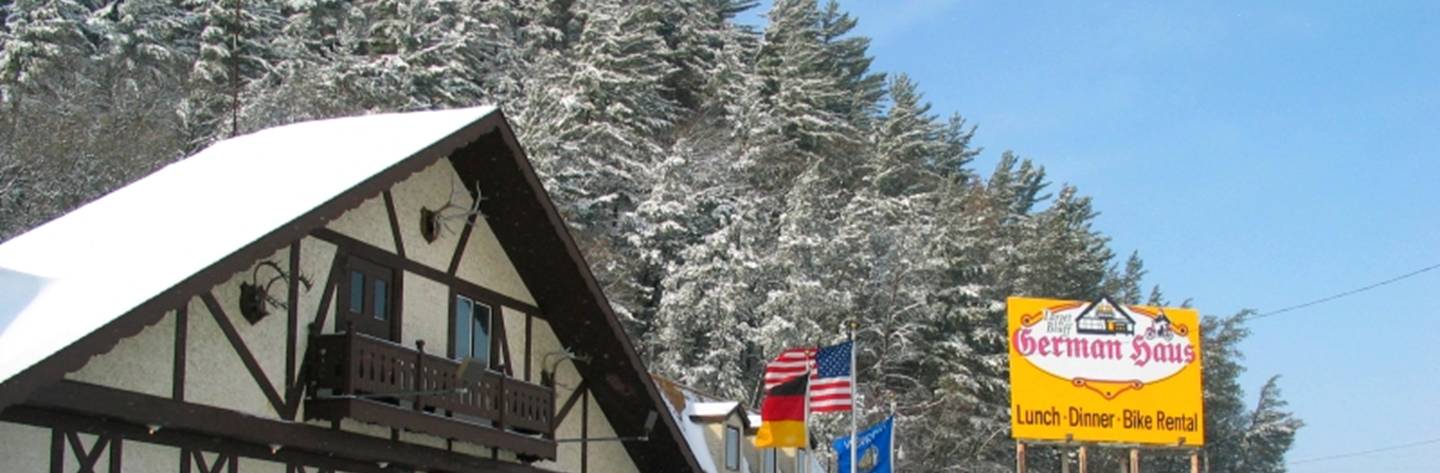 Snow covered trees create a stunning winter backdrop for the Target Bluff German Haus.