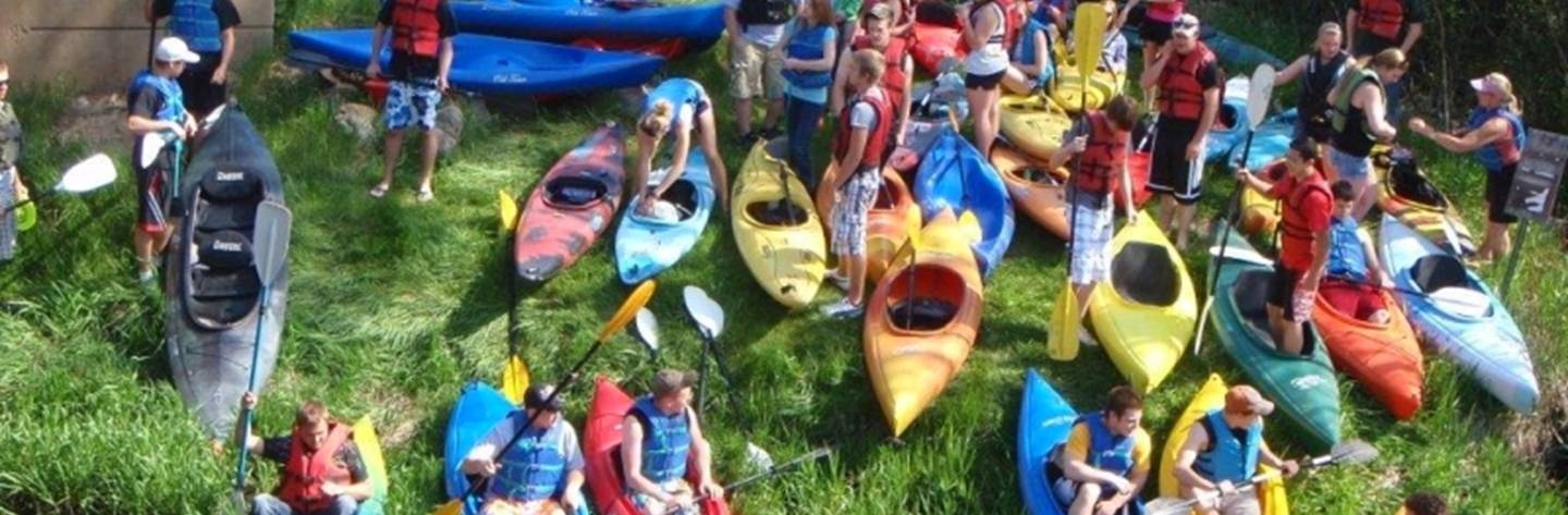 Excited visitors prepare to kayak the Pine River.