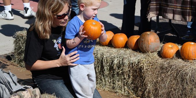 Children can try to knock down colorfully decorated pins in Pumpkin Bowling!