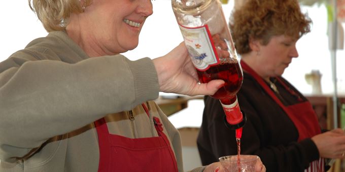 Pouring wine at the Wet Whistle Wine Fest