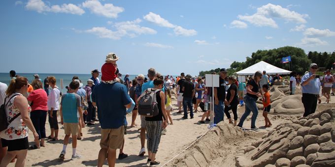 People walking on the beach at Wisconsin Sand Sculpting Festival