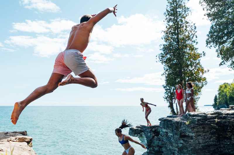 Friends Cliff Jump In Lake Michigan At Cave Point County Park In Door County