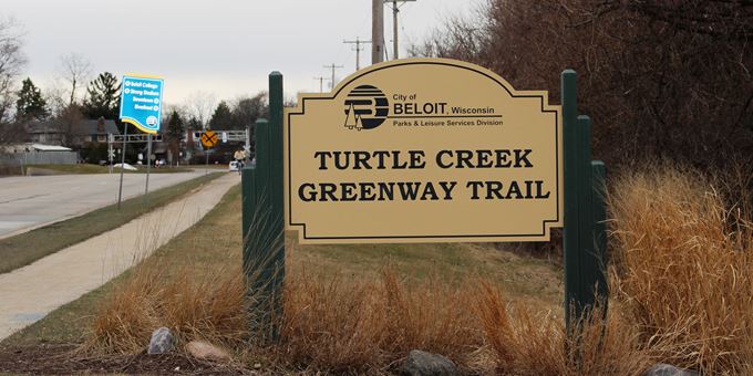 The Turtle Creek trail sign by the parking lot entrance on Milwaukee Road