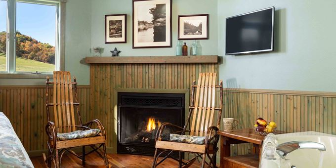 Bentwood oak and hickory amish-made rocking chairs in front of the fireplace inside The Cottage at Justin Trails Resort.