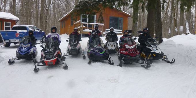 Group of snowmobilers ready to hit the trails. We&#39;ve got over 1200 miles of trails to explore in the Cable Area!