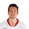 A person wearing a white-and-red Wisconsin hockey jersey with the number 14. The background is plain white.