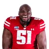 A person in a Wisconsin Badgers football uniform, number 51, poses energetically. The background is plain white.