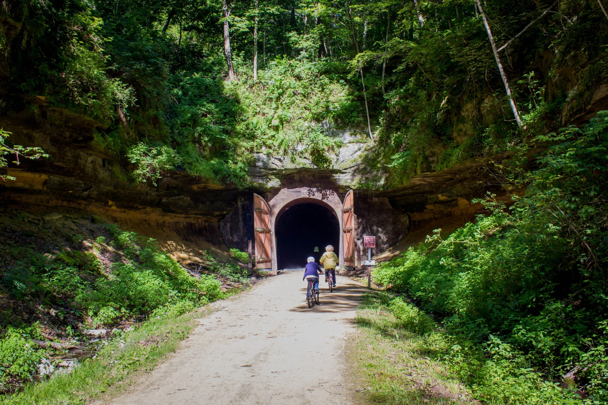 Grandma and child biking into tunnel