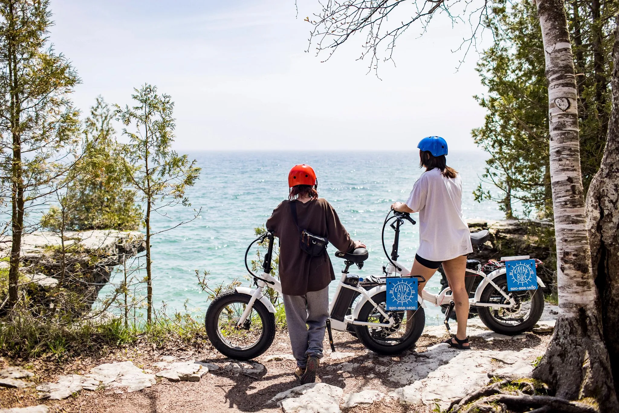 friends enjoying view at cave point door county bikes