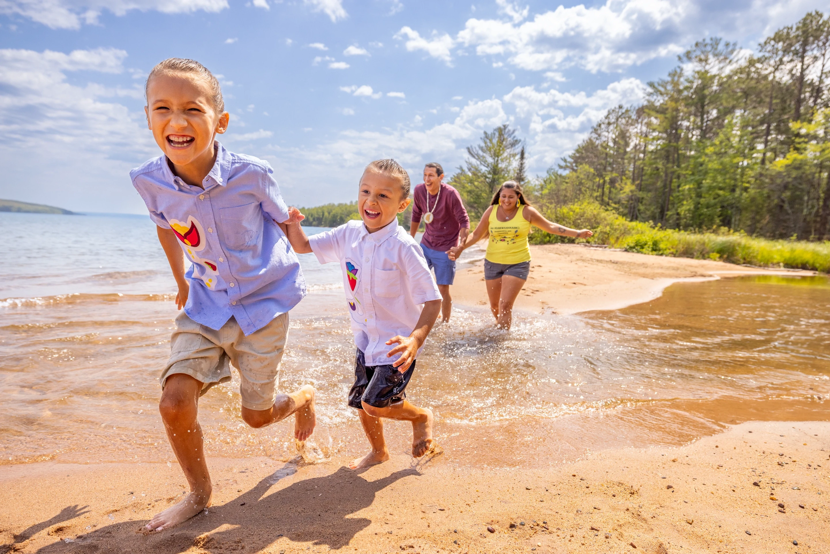 027 Brothers Run Together With Parents Behind Them-Frog Bay Tribal National Park Apostle Islands