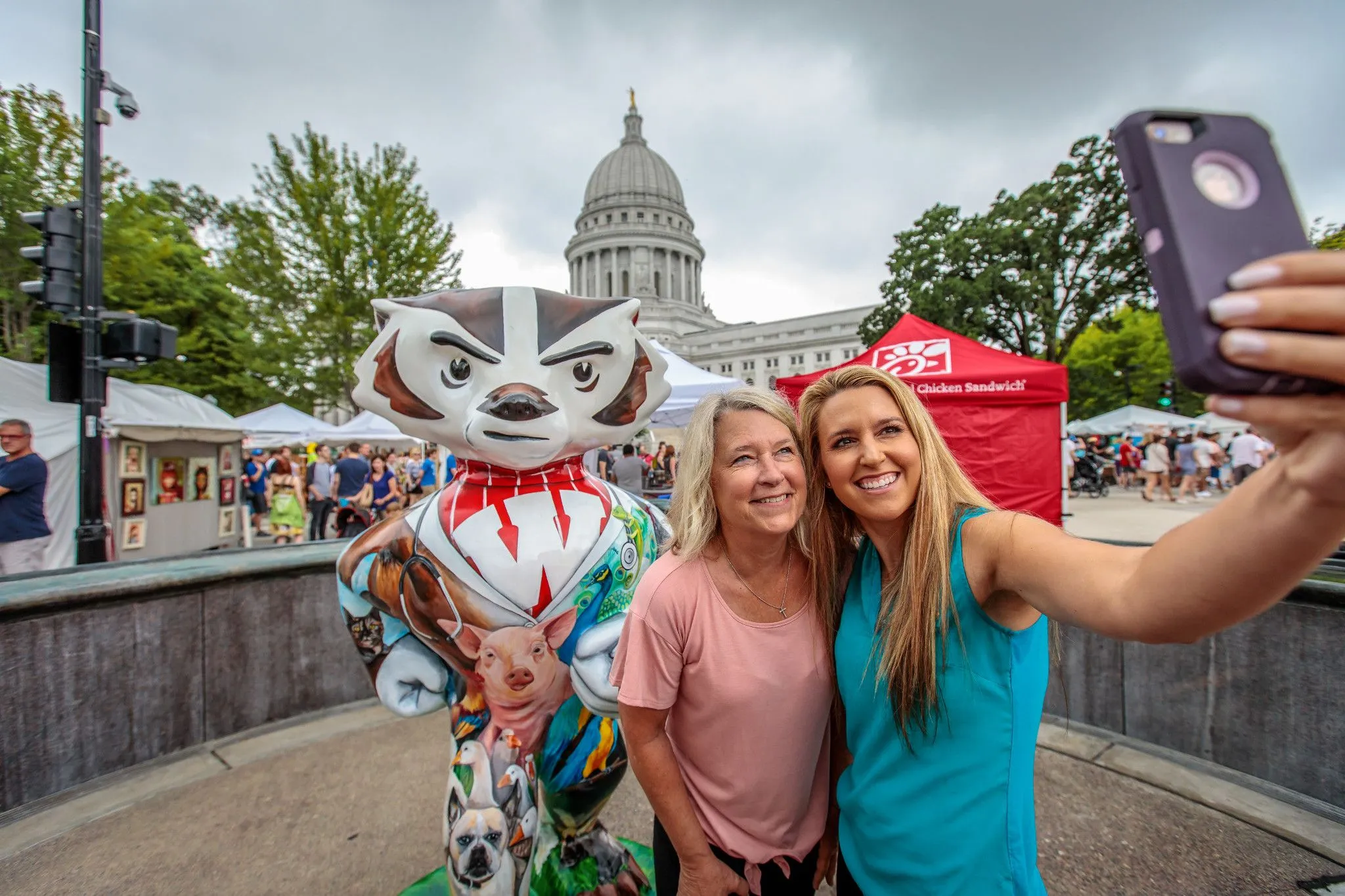 mother and daughter take selfie at art fair on the square mother and daughter take selfie at art fair on the square