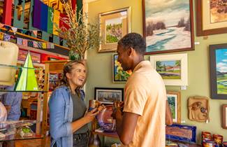 f55d02d0-6bd7-4b39-b05a-f73f5d811613-095-couple-browse-art-at-gallery-in-downtown-bayfield