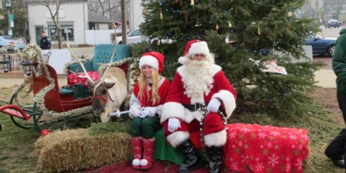 Santa with one of his elves and reindeer.