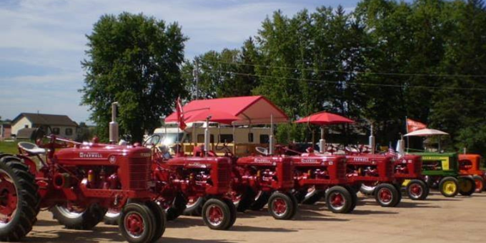 Red tractors lined up on display.