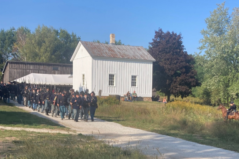 a white house with men in uniform walking for Civil War Remembered event