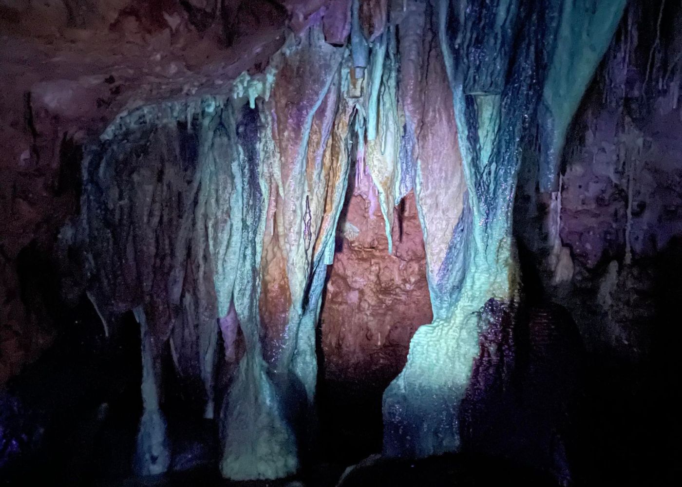 Cave formations glowing under a UV light