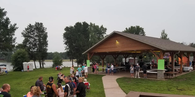 People attending Lake Camelot Frolics enjoying the music and food.