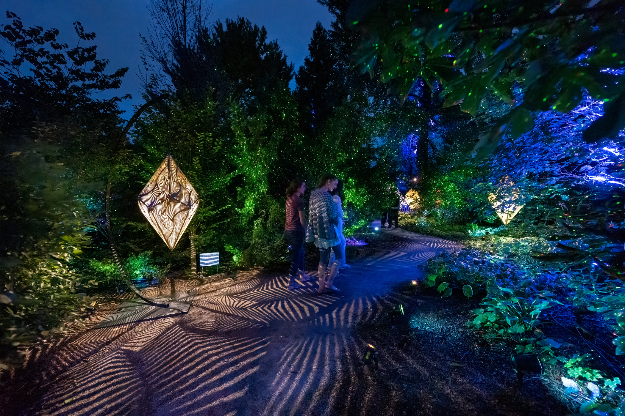 Visitors wander along a path at The Nature of Light.