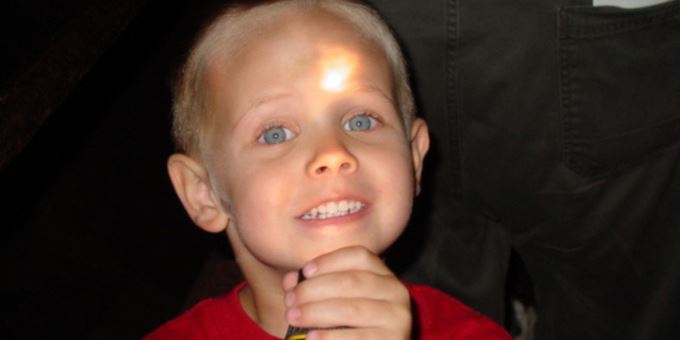 Kid shines flashlight in face at Cave of the MOunds