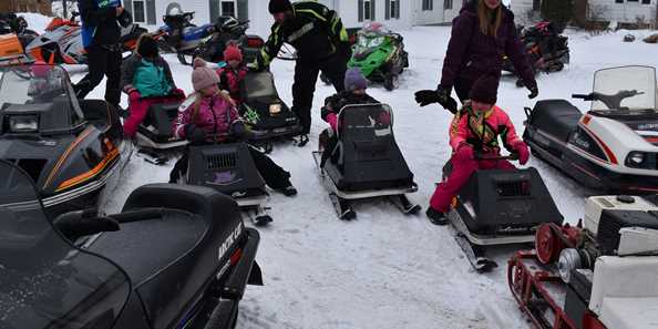 Youngsters even get into riding antique snowmobiles during the Classic Cruise