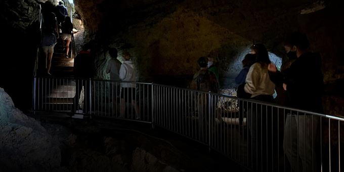Group explores Cave of the Mounds using handheld lights