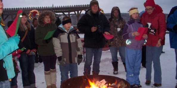 Carolers around the fire pit