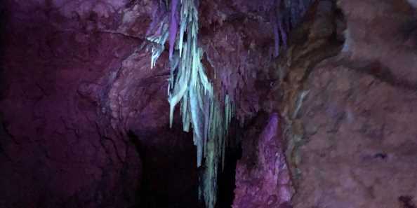 Formations glow under UV light in Cave of the Mounds