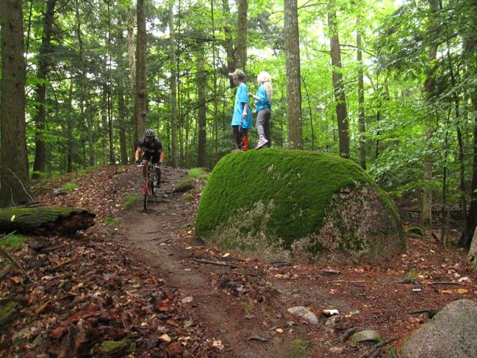 Mountain biker pass one of the boulders on the Nicolet Roche Trail.