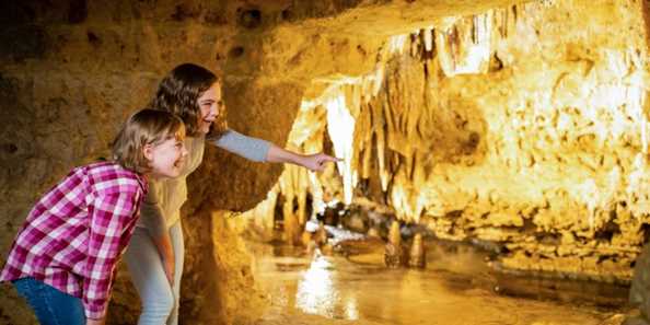 Two young girls area amazed by the Cave of the Mounds beautiful formations.