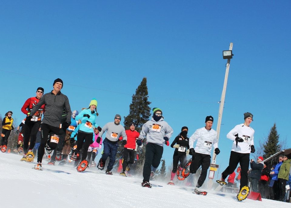 Snowshoers take off from the start line of the Moose Tracks snowshoe race.