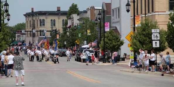 The crowd lines downtown Oconomowoc streets to watch the Memorial Day procession.