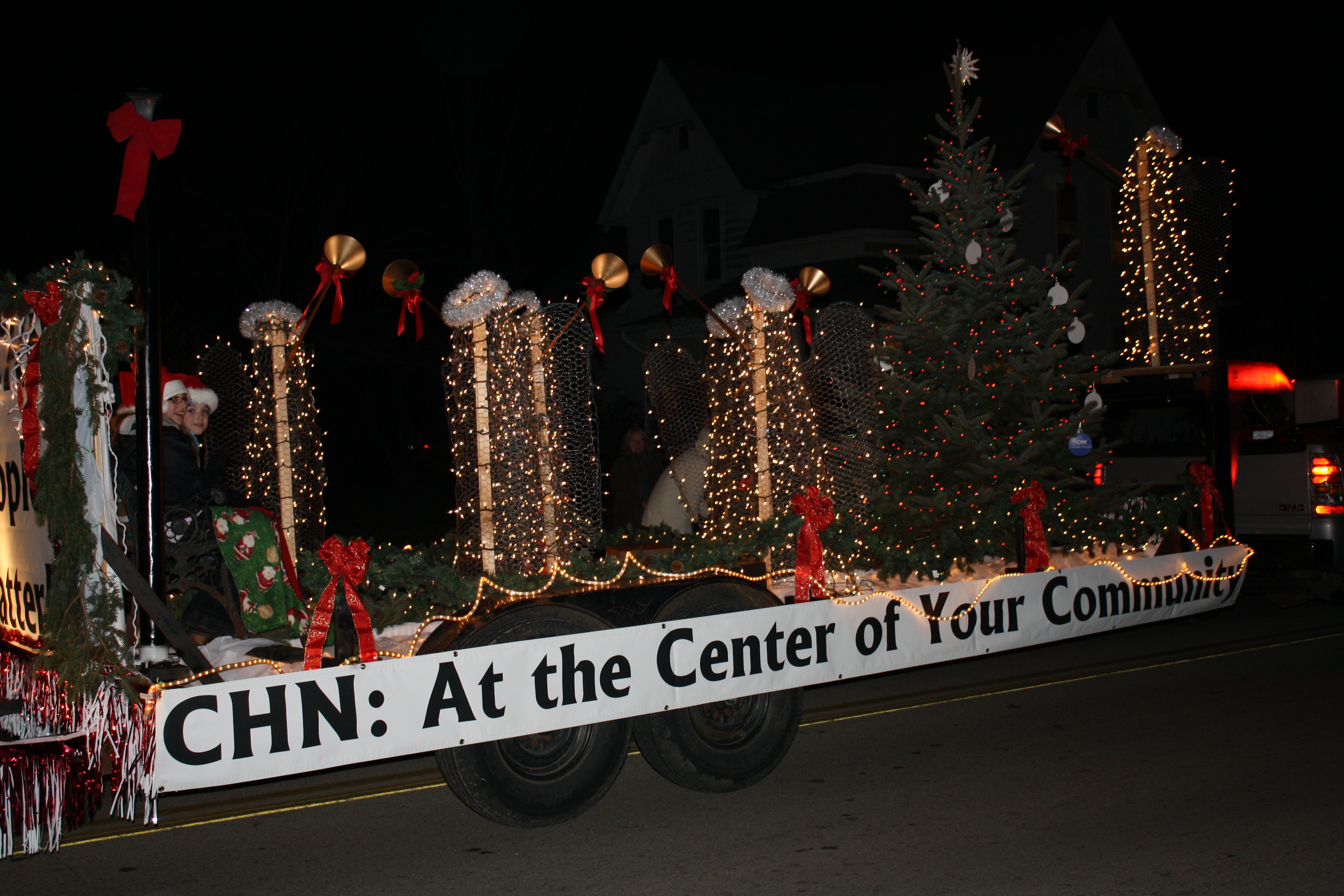 Hundreds of people gather along the parade route to watch