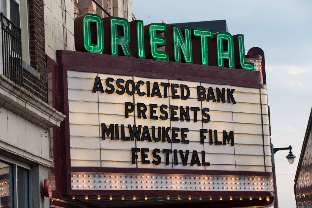 Marquee of the historic Oriental Theatre in Milwaukee displaying a sign that reads “Associated Bank Presents Milwaukee Film Festival.”