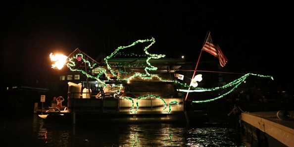 Once the sun goes down, the boat parade begins. Residents dress up their boats with glittering lights and parade around as the emcee describes their creations.