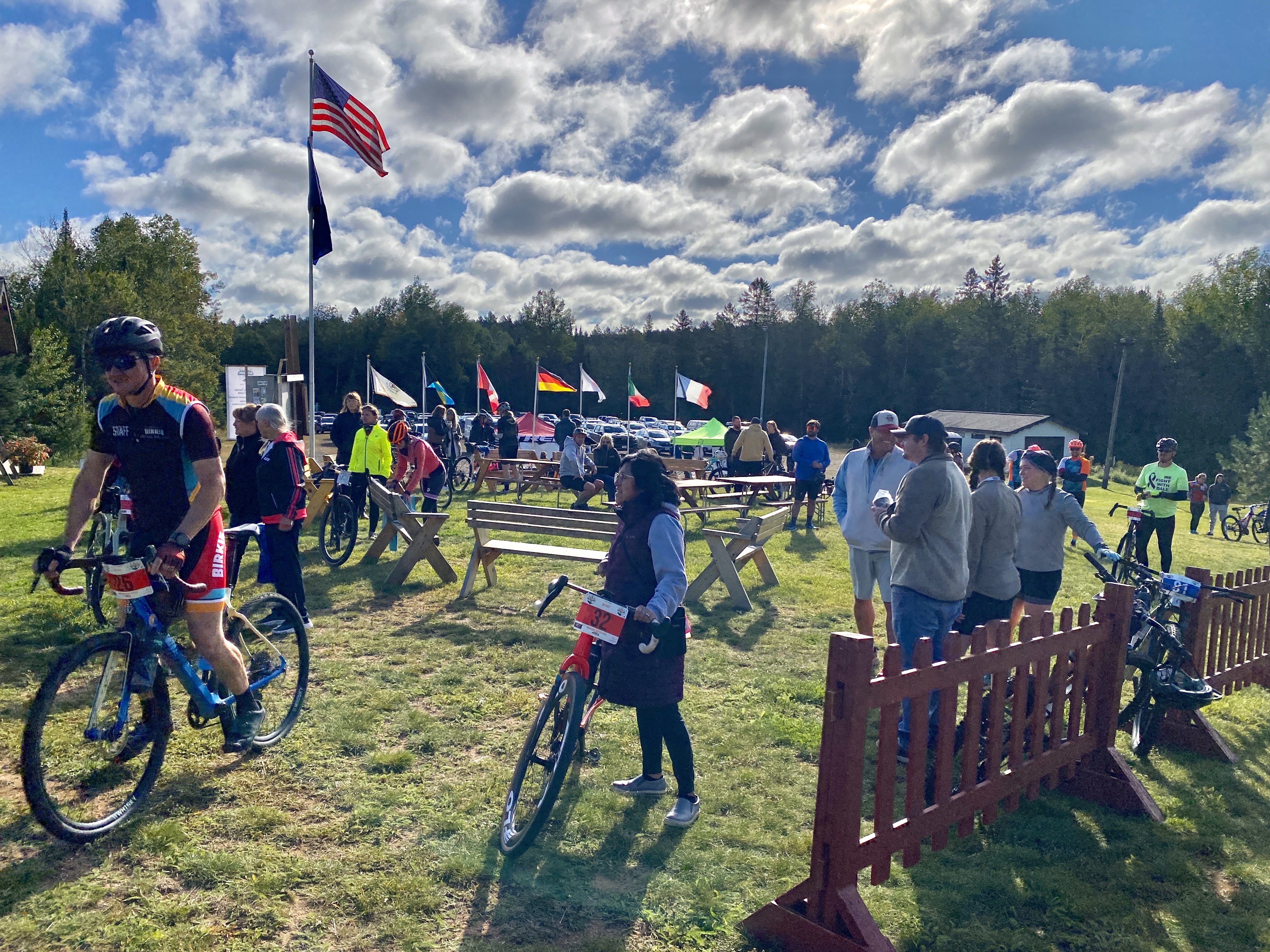 Bike racers get ready to head to the start line under blue skies.