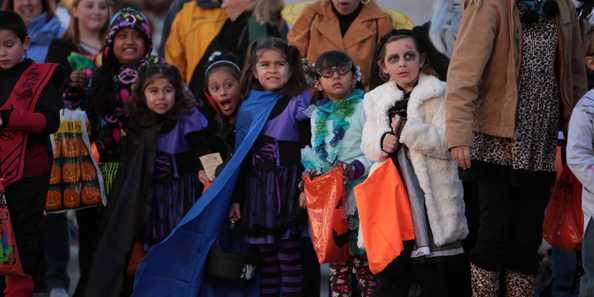Children in costumes wait anxiously for some candy to be tossed during the annual downtown Oconomowoc Halloween Parade.