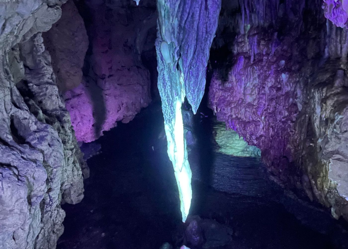 Cave formations glowing under a UV light