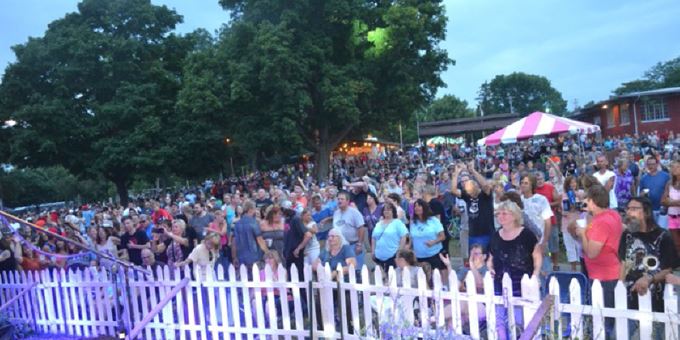View of the crowd gathering during performance by Separate Ways at Riverfest