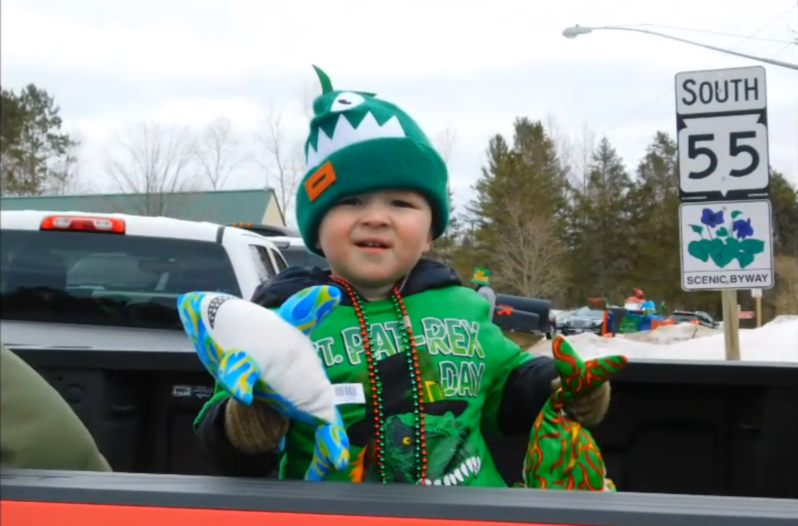 Kids join in the fun aboard the Pickerel-Pearson St. Patrick’s Day Parade floats, dressed in festive green as they wave to the crowd.
