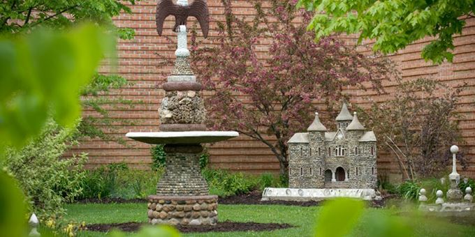 Whimsical miniature castles and other creations grace the Carl Peterson sculpture garden.