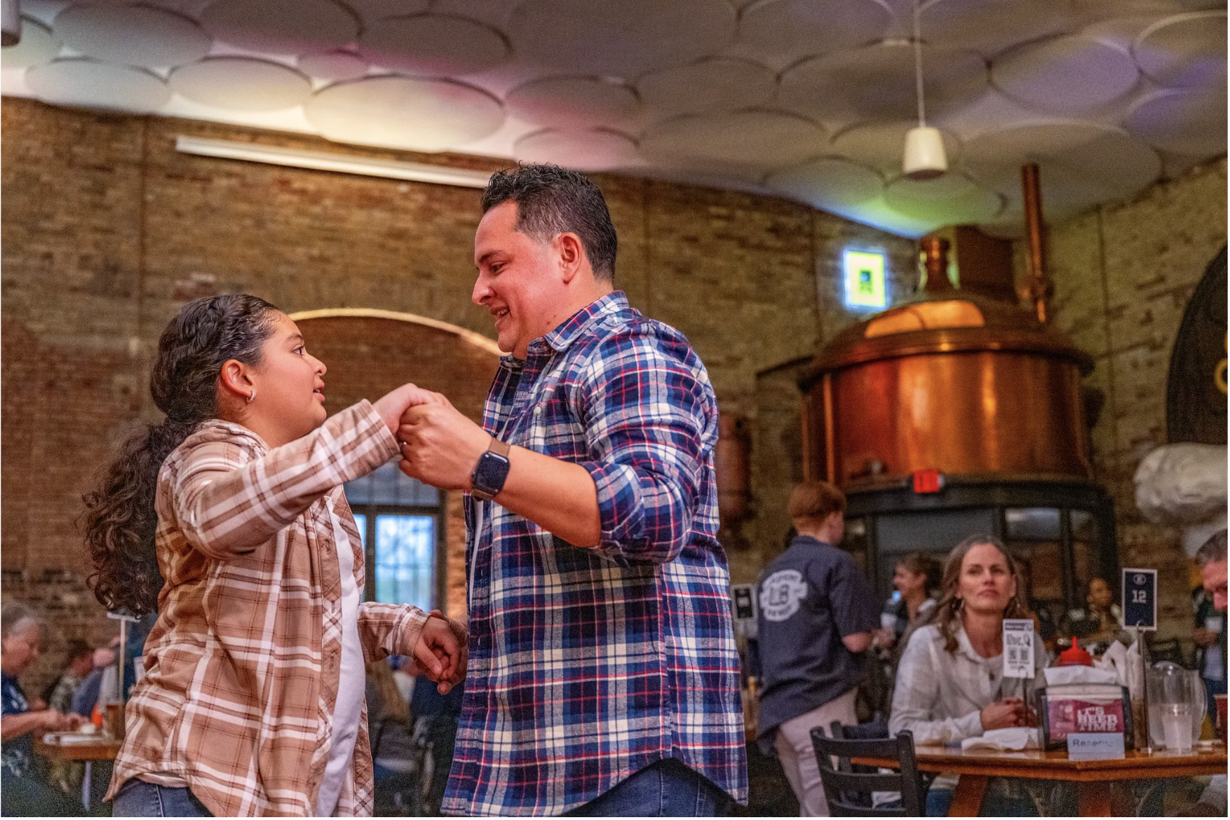 father and daughter dancing at lakefront brewery
