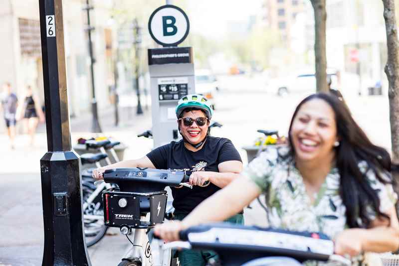 2 friends with rented bikes in downtown Madison