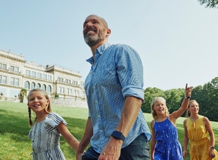 a family explore the gardens outside a historic mansion in lake geneva loading=