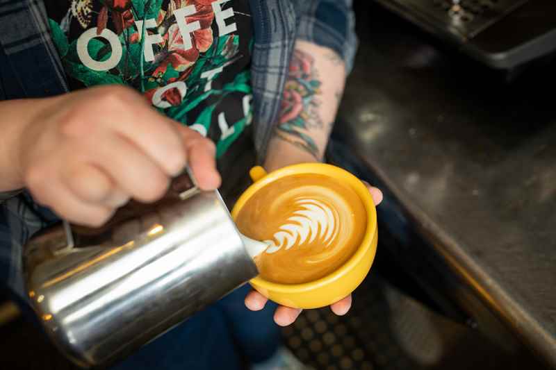 Barista Making Latte Art in Mug