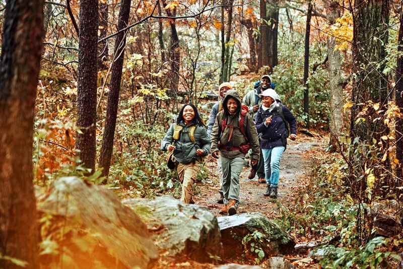 family hiking through the woods at devil's lake state park in baraboo