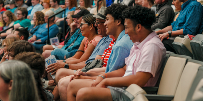 friends seated watching an event at the American Players Theater