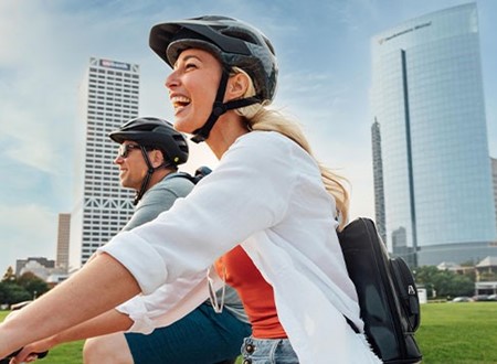 couple biking in the city loading=