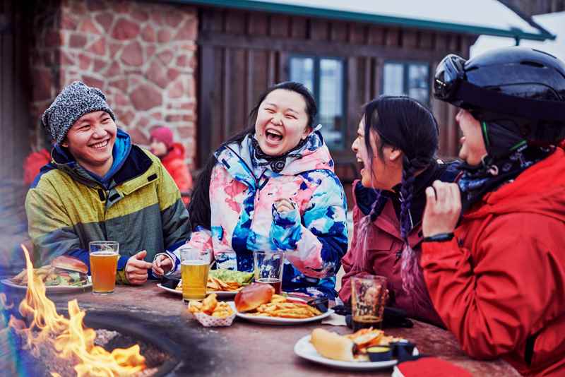 friends taking a break from skiing and enjoying a meal