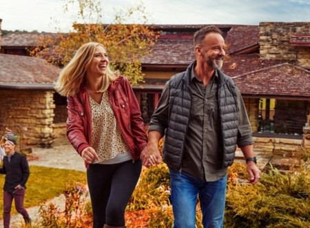 couples explore the grounds outside taliesen in spring green loading=