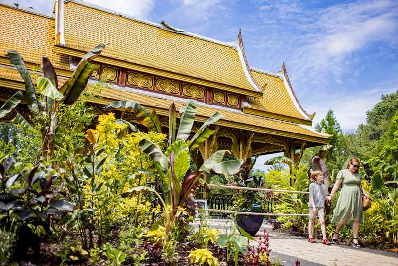 Mother and child walking in front of the Thai pavilion at Olbrich Botanical Gardens